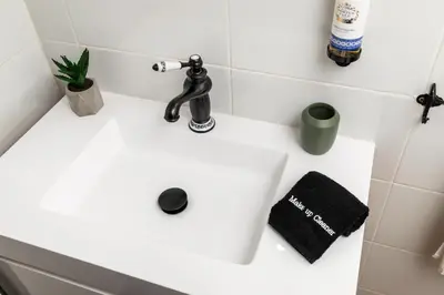 a white bathroom sink with a faucet and a towel at Porto Essence in Porto