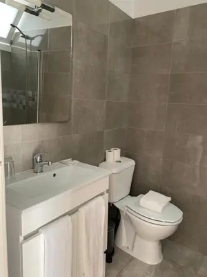 a bathroom with a shower and a bathtub with a glass door at GuestHouse Marquês in Porto