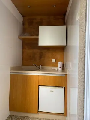 an attic hallway with a skylight and a brick wall at GuestHouse Marquês in Porto