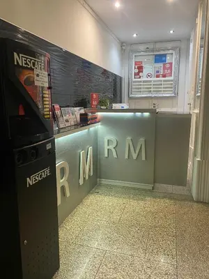 a room with a nintendo nrm machine next to a counter at GuestHouse Marquês in Porto