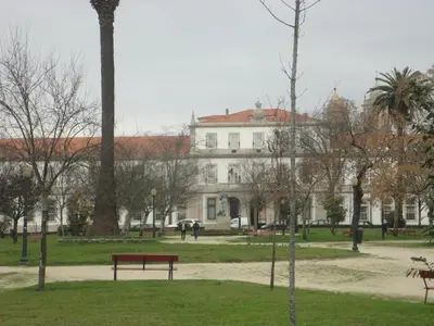 a park with a red bench in front of a building at Oporto Like Home IV - Mezzanine in Porto