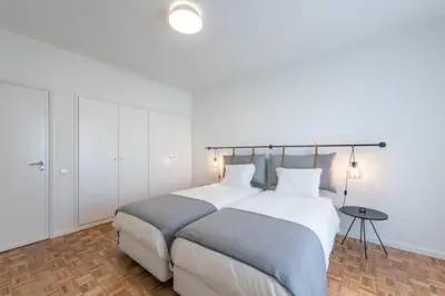 a bedroom with a large bed and a table at GuestReady - Cn Apartment in Porto