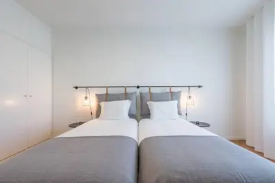 a bedroom with a large bed with two pillows at GuestReady - Cn Apartment in Porto
