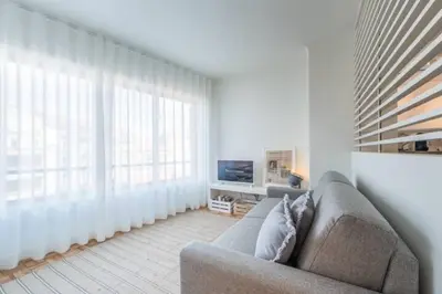 a living room with a couch and a large window at GuestReady - Cn Apartment in Porto