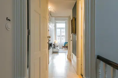 a hallway with a door leading to a living room at Visconde Mezzanine in Porto