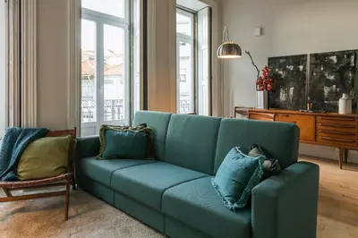a blue couch with pillows in a living room at Visconde Mezzanine in Porto