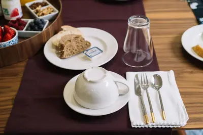 a table with plates of food and a cup of tea at D'Autor Apartments Sá da Bandeira in Porto