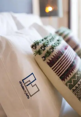 two towels sitting on top of a bed at Virtudes City Lofts in Porto