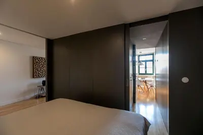 a bedroom with black walls and a bed at Modern 18th Century Flat in Porto