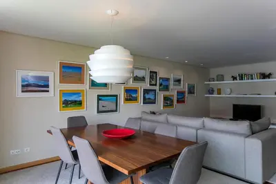 a dining room with a table and a couch at Comfy Luxury Apartment in Porto