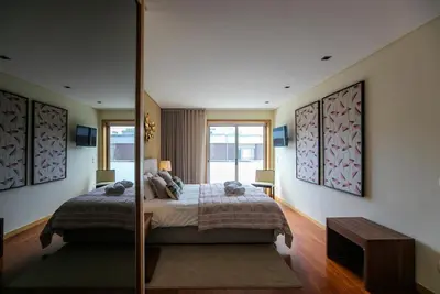 a bedroom with a bed and a large window at Comfy Luxury Apartment in Porto