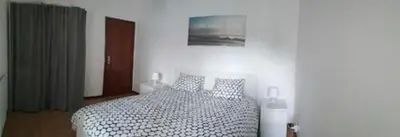 a bedroom with a bed with a black and white comforter at Cocooning Appartement in Porto