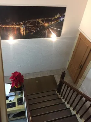 a stairway with a painting on the wall at Lira Guest House B&B in Porto