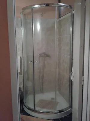 a shower with a glass door in a bathroom at Lira Guest House B&B in Porto