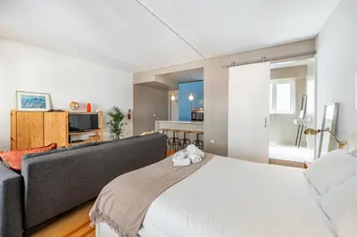 a white bedroom with a bed and a couch at São Miguel 50 in Porto