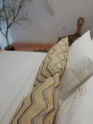a tie sitting on top of a white pillow at Porto Feeling in Porto