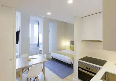 a bathroom with a sink and a toilet and a mirror at Mercado dos Poetas – Tourism Apartments in Porto