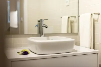 a bathroom with a white sink and a mirror at Studio Tomás Gonzaga in Porto