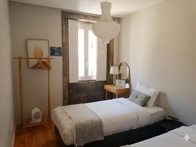 a bedroom with a large bed with towels on it at Oporto City View - Santo Ildefonso in Porto