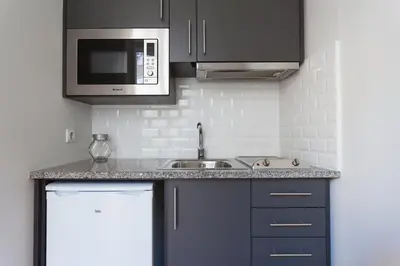 a kitchen with a sink and a counter top at Oporto City View - Santo Ildefonso in Porto
