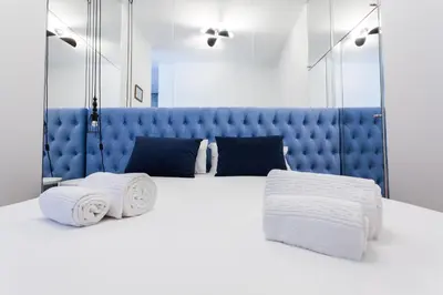 a bedroom with a white bed with towels on it at Oporto City View - Santo Ildefonso in Porto