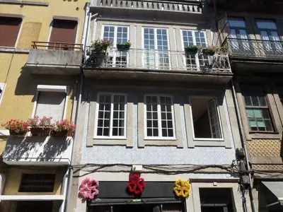 a building with flowerpots on the side of it at Oporto City View - Santo Ildefonso in Porto
