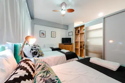 a bedroom with two beds and a ceiling fan at Merc Porto Bolhão Place in Porto