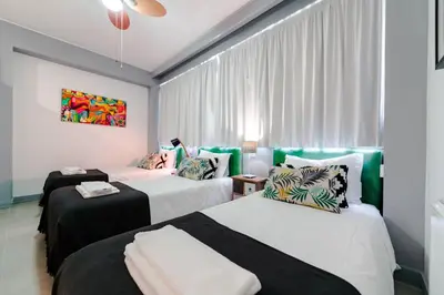 two beds in a room with green and white at Merc Porto Bolhão Place in Porto