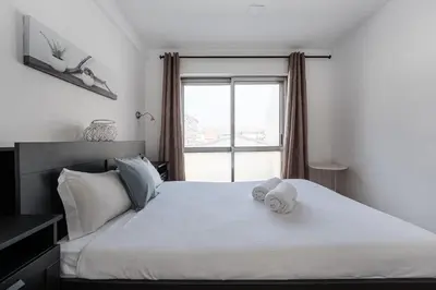 a bedroom with a white bed with towels on it at GuestReady - Beautiful Plateau in Porto