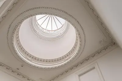 an ornate ceiling in a building with a window at GuestReady - Charming Studio in Porto! in Porto