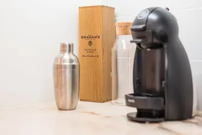 a coffee maker and a bottle on a counter at GuestReady - Charming Studio in Porto! in Porto
