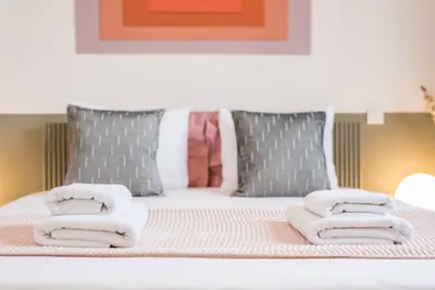 a bed with towels and pillows on top of it at GuestReady - Charming Studio in Porto! in Porto