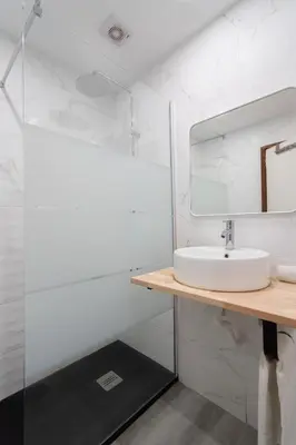 a bathroom with a sink and a mirror at Renovated 3BR Apt Near City Hotspots with Great Value in Porto