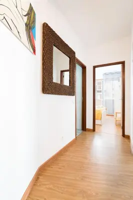 a living room with a mirror on the wall at Renovated 3BR Apt Near City Hotspots with Great Value in Porto