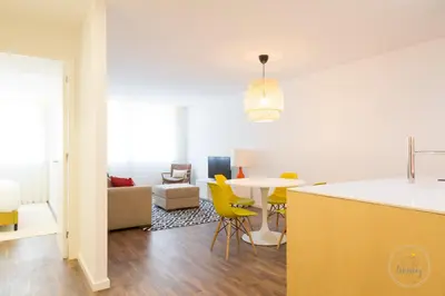 a kitchen and living room with a table and yellow chairs at Oporto Ceuta Residences - Residence 1 by We Do Living in Porto