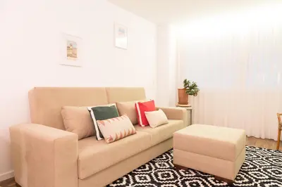 a living room with a couch with pillows on it at Oporto Ceuta Residences - Residence 1 by We Do Living in Porto