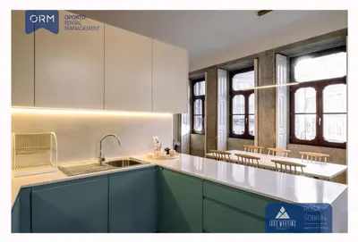 a kitchen with green cabinets and white counter tops at ORM - Bainharia Apartment in Porto