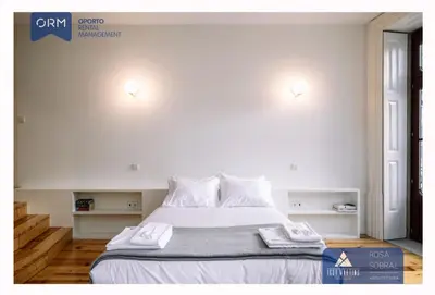 a bedroom with a bed with two towels on it at ORM - Bainharia Apartment in Porto