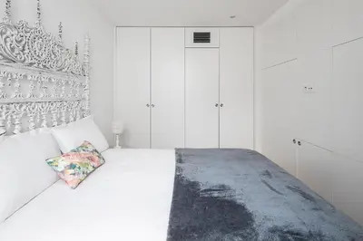 a bedroom with a bed with a green headboard at Downtown Historic Apartments in Porto
