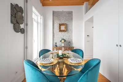 a glass table with plates of food on it at Downtown Historic Apartments in Porto