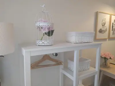 a white table with a bird cage with a flower in it at Oporto Golden View Vitória in Porto