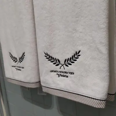 two towels on a shelf in a bathroom at Oporto Golden View Vitória in Porto