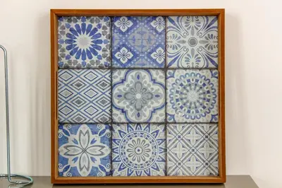 a wall with blue and white tiles in a wooden frame at Bonjardim Flats - T1 in Porto