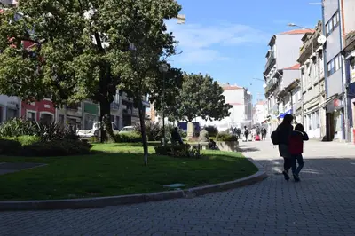 a woman and a child walking down a street at Suite In in Porto