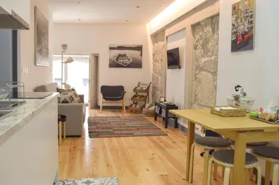 a kitchen and living room with a table and chairs at Suite In in Porto