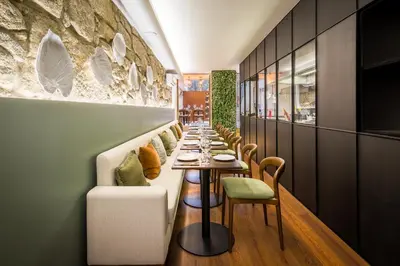 a bar in a restaurant with chairs and a counter at Gallery Hostel in Porto