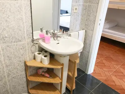 a bathroom with a sink and a mirror at Clérigos Apartments in Porto