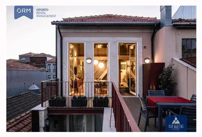 a balcony of a house with a table and chairs at ORM - Almada Terrace Apartment in Porto
