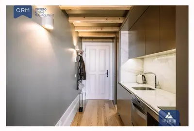 a kitchen with a sink and a white door at ORM - Almada Terrace Apartment in Porto