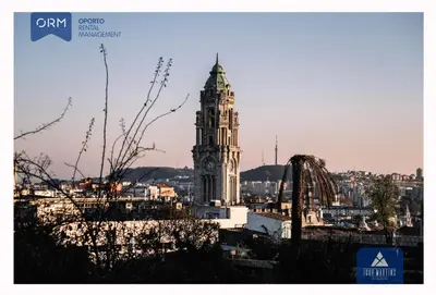 a building with a clock tower in a city at ORM - Almada Terrace Apartment in Porto